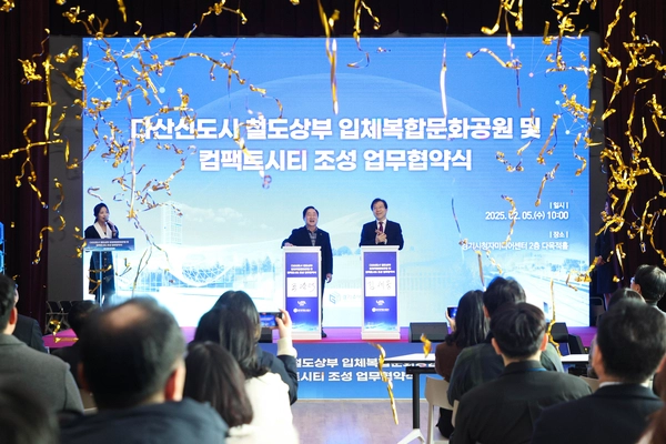 주광덕 남양주시장(왼쪽)과 김세용 GH 사장이 5일 열린 ‘다산신도시 철도상부 입체복합문화공원 및 컴팩트시티 조성 업무협약식’에서 축포를 터뜨리고 있다. /남양주시 제공