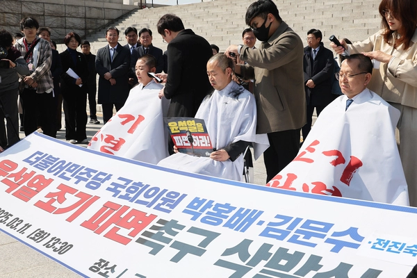 11일 서울 여의도 국회 본청 앞 계단에서 더불어민주당 전진숙(왼쪽부터), 박홍배, 김문수 의원이 윤석열 대통령 조기파면 등을 촉구하며 삭발하고 있다. 2025.3.11 /연합뉴스