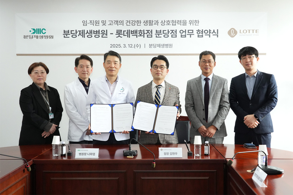 분당제생병원 나화엽 병원장과 롯데백화점 분당점 김현우 점장이 업무협약을 체결한 뒤 협약서를 들어보이고 있다. /분당제생병원 제공