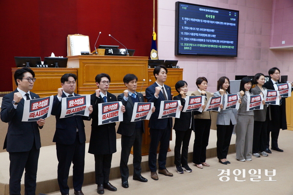 안양시의회 민주당 의원들이 13일 오전 제301회 임시회 제2차 본회의가 끝난 직후 본회의장에서 ‘윤석열 대통령 파면 촉구 결의문’을 발표하면서 파면을 촉구하는 구호를 외치고 있다. 2025.3.13 안양/박상일기자 metro@kyeongin.com
