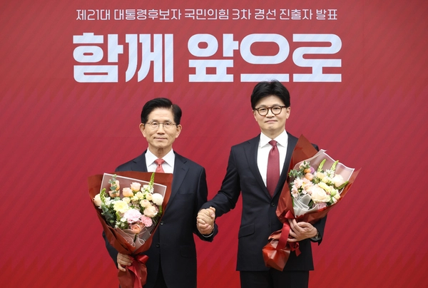 국민의힘 대선 최종 경선에 진출한 김문수(왼쪽)·한동훈 후보가 29일 서울 여의도 당사에서 2차 경선 결과 발표 후 꽃다발을 들고 기념촬영을 하고 있다. 2025.4.29 /연합뉴스