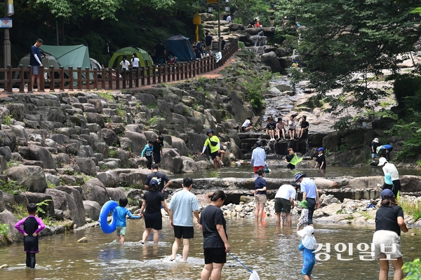 낮 최고기온이 33도까지 상승하는 등 무더운 날씨가 이어진 6일 오후 과천시 관악산 계곡을 찾은 시민들이 물놀이를 하며 더위를 식히고 있다. 2025.7.6 /최은성기자 ces7198@kyeongin.com